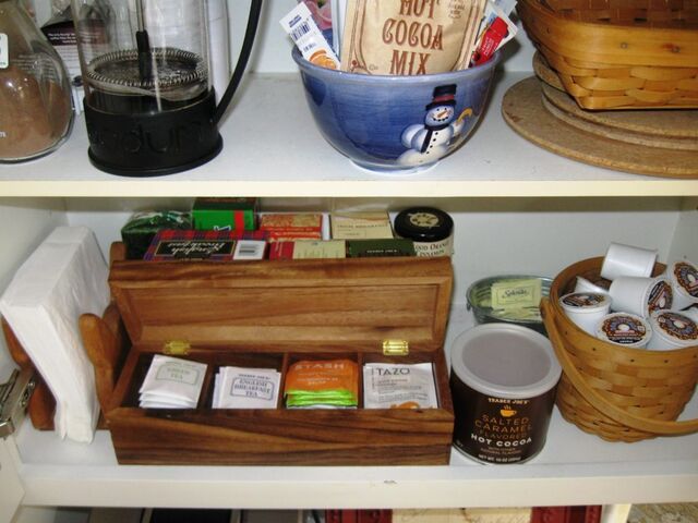 I use a tea box for a selection of teas and a Longaberger basket for coffee pods in the cupboard above my beverage station.