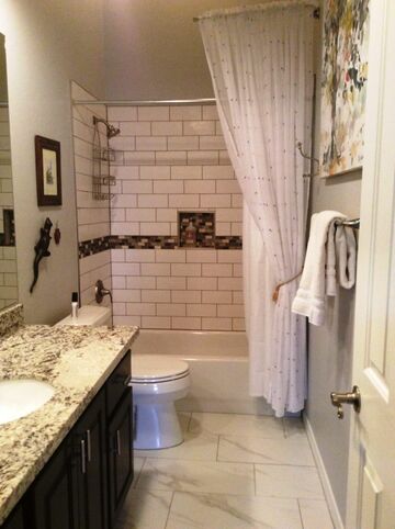 Here is the final product:  Subway tile and accent glass around the bathtub, new brushed nickel fixtures and new Dunn Edwards Cloud paint