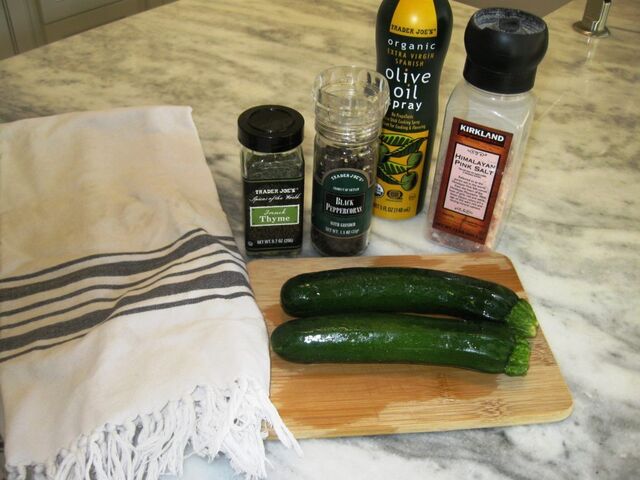 Prepping for grilled zucchini with thyme, black pepper, Himalayan pink salt and olive oil spray