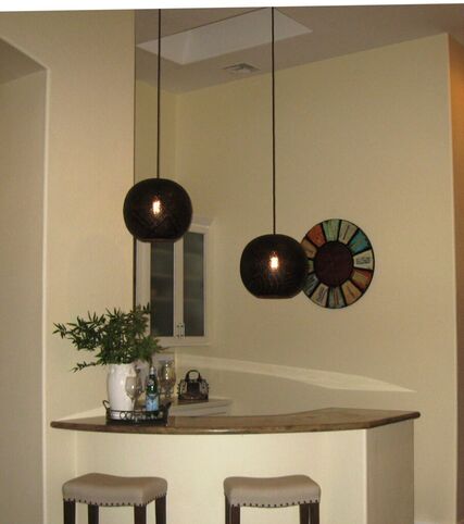 These perforated metal globes are perfect over the bar.