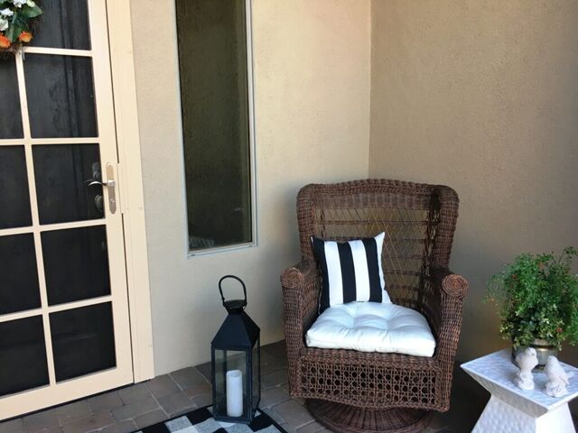 My old wicker chair gets a new pillow and my old table gets a fresh coat of paint