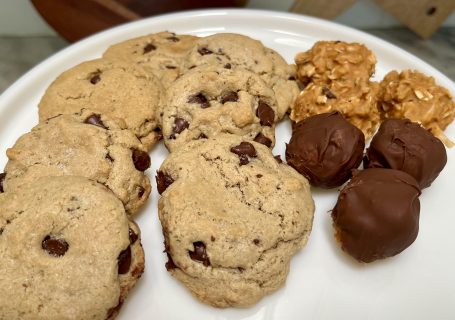 Healthy chocolate desserts including tahini chocolate chip cookies, peanut butter energy balls, and chocolate-dipped peanut butter treats.