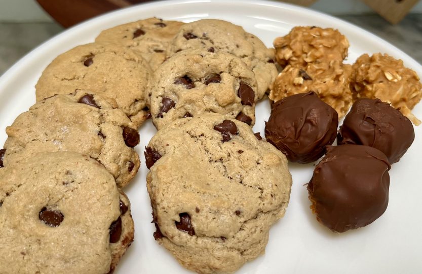 Healthy chocolate desserts including tahini chocolate chip cookies, peanut butter energy balls, and chocolate-dipped peanut butter treats.