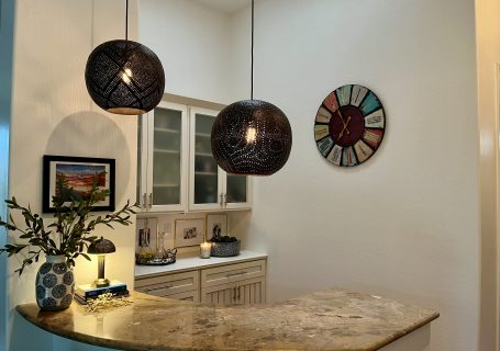 Blue and white home bar decorated with olive leaves and brass accents