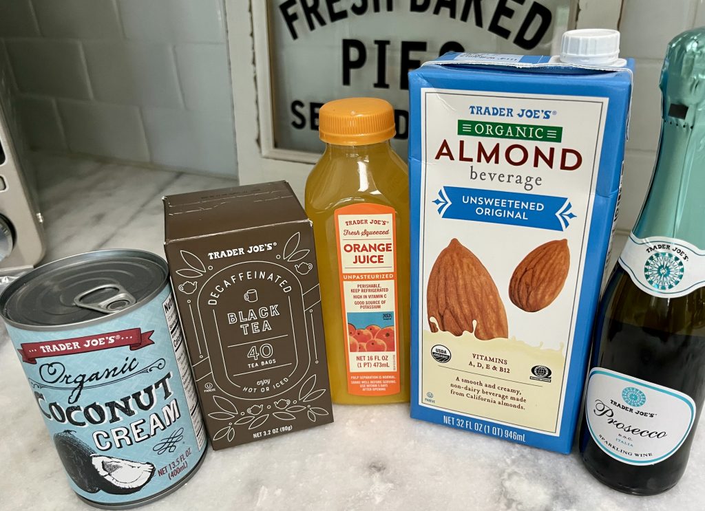 Trader Joe's orange juice, decaf tea, almond beverage and Prosecco