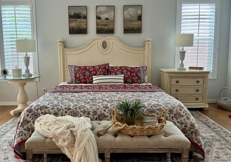 cozy bedroom with red and cream bedding decorated for fall in Arizona