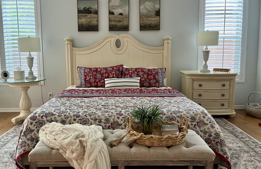 cozy bedroom with red and cream bedding decorated for fall in Arizona
