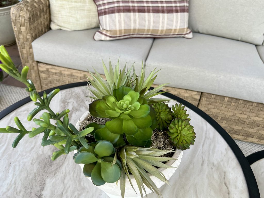Faux cactus arrangement on outdoor coffee table for a simple fall patio update