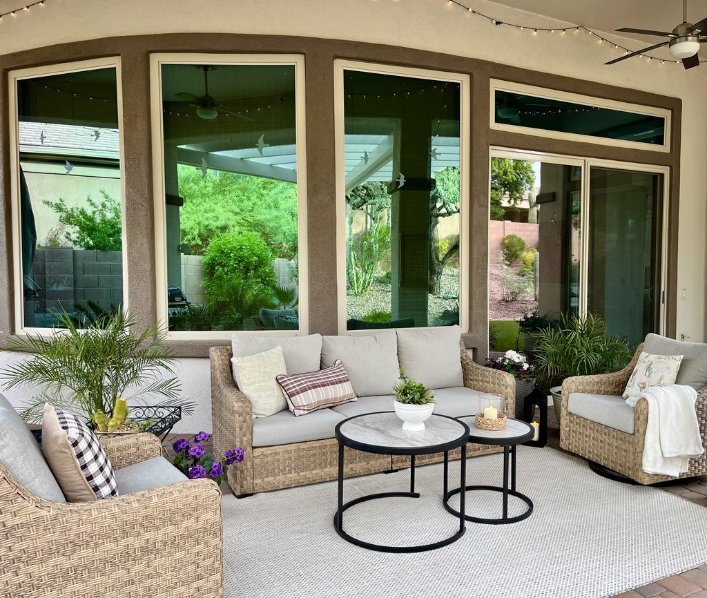 Minimal fall patio with plaid pillows, cream throw blanket and cactus centerpiece