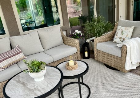 Minimal fall patio with plaid pillows, cream throw blanket and cactus centerpiece