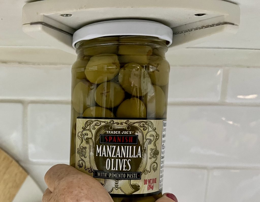 Jar of Trader Joe's olives held in an under-cabinet jar opener