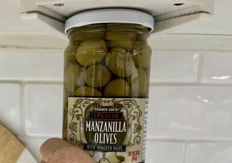 Jar of Trader Joe's olives held in an under-cabinet jar opener