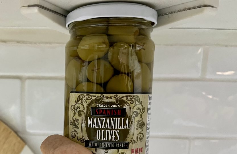 Jar of Trader Joe's olives held in an under-cabinet jar opener